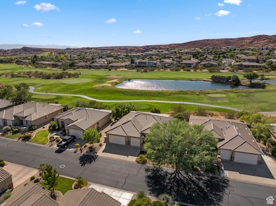 Aerial perspective of suburban area featuring a local golf course and a water and mountain view