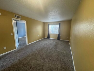Spare room featuring baseboards, visible vents, da