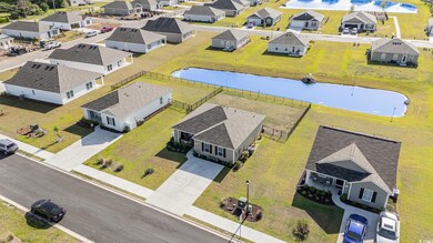 Birds eye view of property with a water view and a