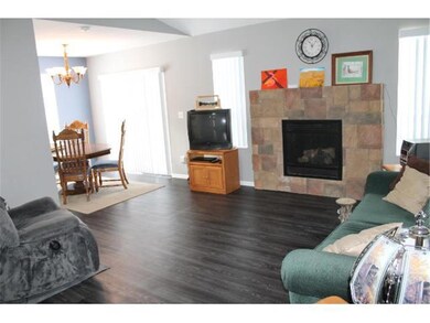 Living room with brick gas fireplace.