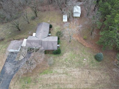 Plenty of parking space with a 2 car garage, carport, and driveway with parking pad.  Storage building and RV shop located in back.