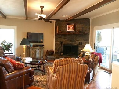 Great-room with wood burning fireplace leads to co