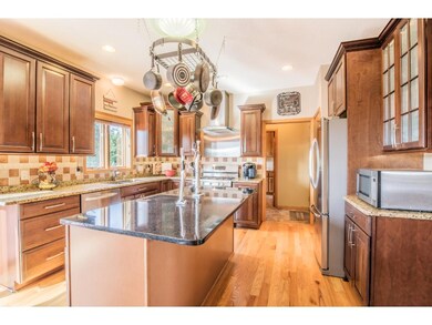 Kitchen features newer cabinetry, granite countert