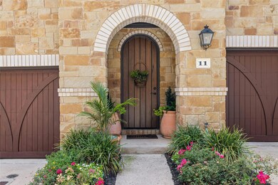 Property entrance with stone siding, a garage, an
