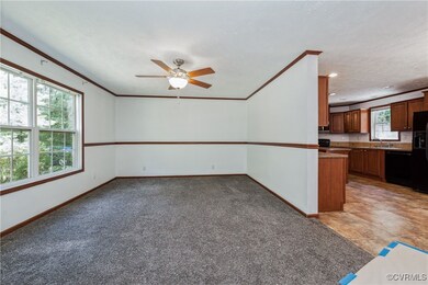 Empty room with crown molding, ceiling fan, basebo