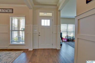 Gleaming engineered wood flooring flows throughout the main living areas and halls.