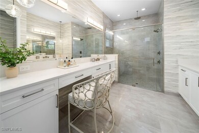 Full bath featuring vanity, a stall shower, and ti