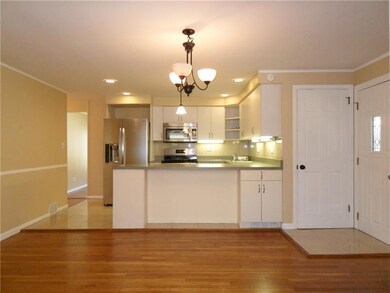 View of Kitchen, Dining Room area - Door to the Right with Window Leads to Side Yard.  Other Door on Right Leads to the Basement.