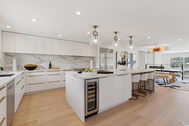 The ultimate chef's kitchen with an expansive center island with an abundance of cabinet spaces, a prep sink, Wolf range, Subzero refrigerator, Bosch dishwasher, wine refrigerator and convection oven.