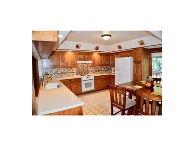 Remodeled kitchen with decorator tile backsplashes