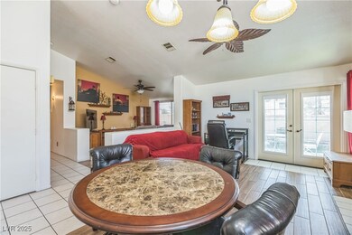 Dining room featuring a ceiling fan, vaulted ceili