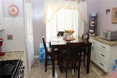 Dining area featuring tile walls