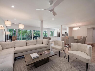 Living room with a chandelier and light hardwood /