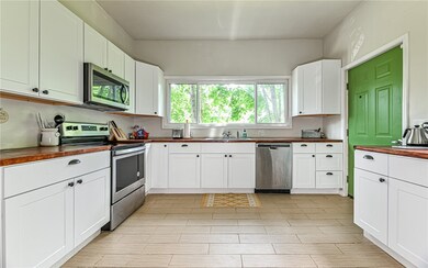 This view of the kitchen, taken from the dining ro