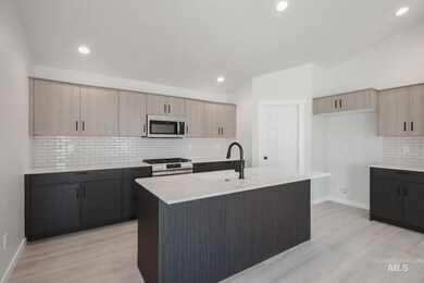 Kitchen featuring backsplash, light brown cabinetry, stainless steel appliances, light stone countertops, and recessed lighting