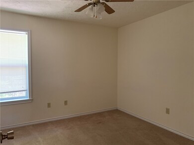 Spare room with carpet floors, ceiling fan, basebo