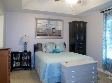 Impressive master bedroom with tray ceiling and ce