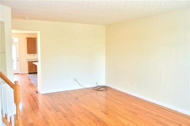 Living room with built-in shelves and powder room.