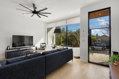 Living area with a ceiling fan, baseboards, light