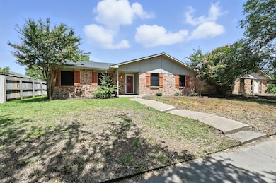 Single story home featuring board and batten siding and brick siding
