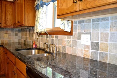 Neutral back splash complements granite.