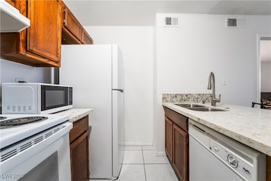Kitchen featuring exhaust hood, visible vents, whi