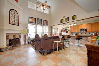 Walk into the living room. Cathedral ceiling. Gas-log fireplace. Windows open to the backyard. Completely open to the kitchen and breakfast area.