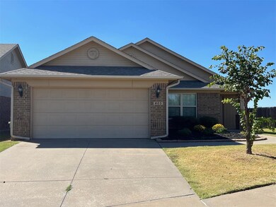 Ranch-style house with a front yard and a garage