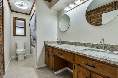 Full bathroom with a sink, toilet, double vanity, 