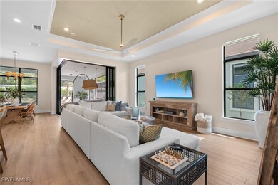 Living room with a raised ceiling, ceiling fan wit