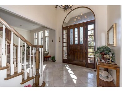 Entry with Tall Ceiling, Beautiful Wood Door, and 