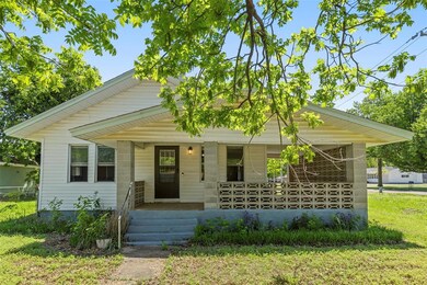 Bungalow featuring covered porch and a front yard
