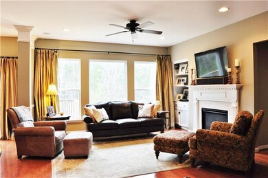 This great room is still a very warm place in an open floor plan, with fireplace, large picture window, built-in book shelves, surround sound speakers in ceiling, recessed lighting...etc