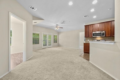 Kitchen with stainless steel microwave, carpet, a