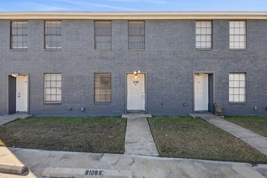 View of front facade featuring brick siding and a front lawn
