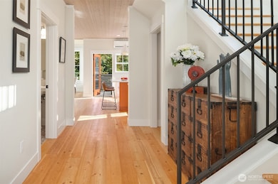 Gleaming solid wood floors grace the entry, living spaces and bedrooms.