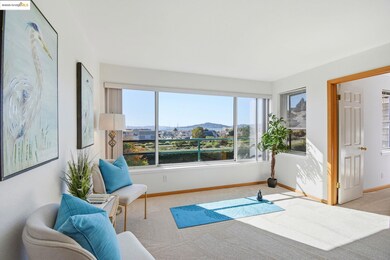 Sitting room with healthy amount of natural light, carpet, and a mountain view