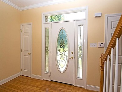 Enter through a custom leaded glass door with side