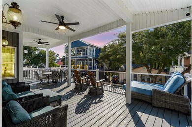 Deck featuring outdoor dining space, ceiling fan, and an outdoor hangout area