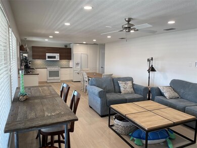 Living area with a ceiling fan, light wood-style 