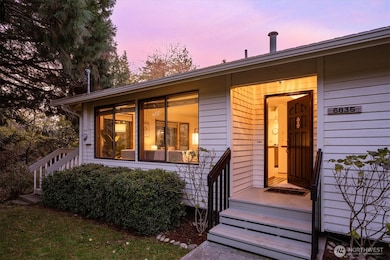 After the tunnel of trees guides you home the entry glows at dusk with warm light and tidy landscaping echoing the same calm welcome found throughout the residence.