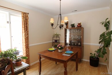 Dining area with chair rail and crown molding.  El