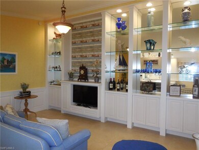 Bar with white cabinets, light tile patterned floo