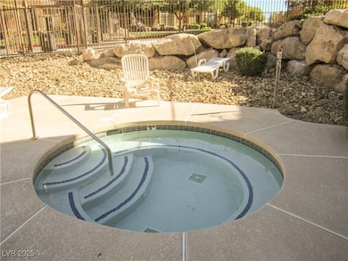 View of swimming pool with a patio and a hot tub