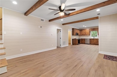 living room featuring wooden walls, light wood finished floors, recessed lighting, a ceiling fan, and beam ceiling
