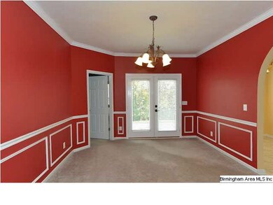 Formal dining room is bold in color and gracious i