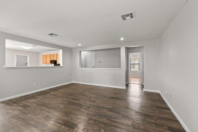 Spare room featuring dark wood-style flooring and
