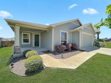 Ranch-style house featuring a garage, driveway, a