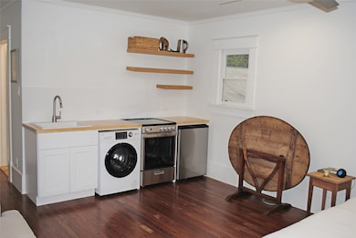 Compact kitchenette featuring a range, fridge, and