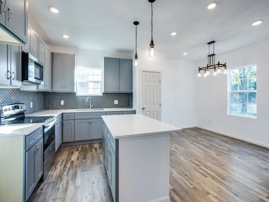 Kitchen featuring a wealth of natural light, a kit